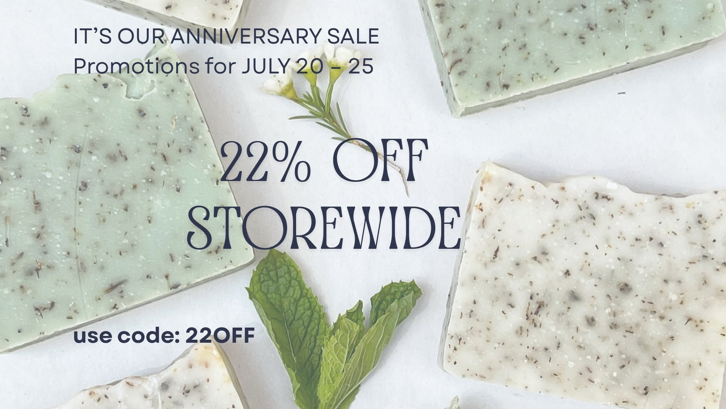 SALUS Promotional sale graphic for a soap studio featuring several rectangular bars of speckled soap on a white background with text reading 'IT'S OUR ANNIVERSARY SALE Promotions for JULY 20 - 25 22% OFF STOREWIDE use code: 22OFF'.