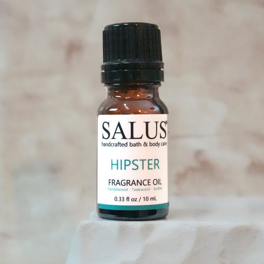 SALUS Hipster fragrance oil, 10 mL amber bottle on a white stone pedestal.