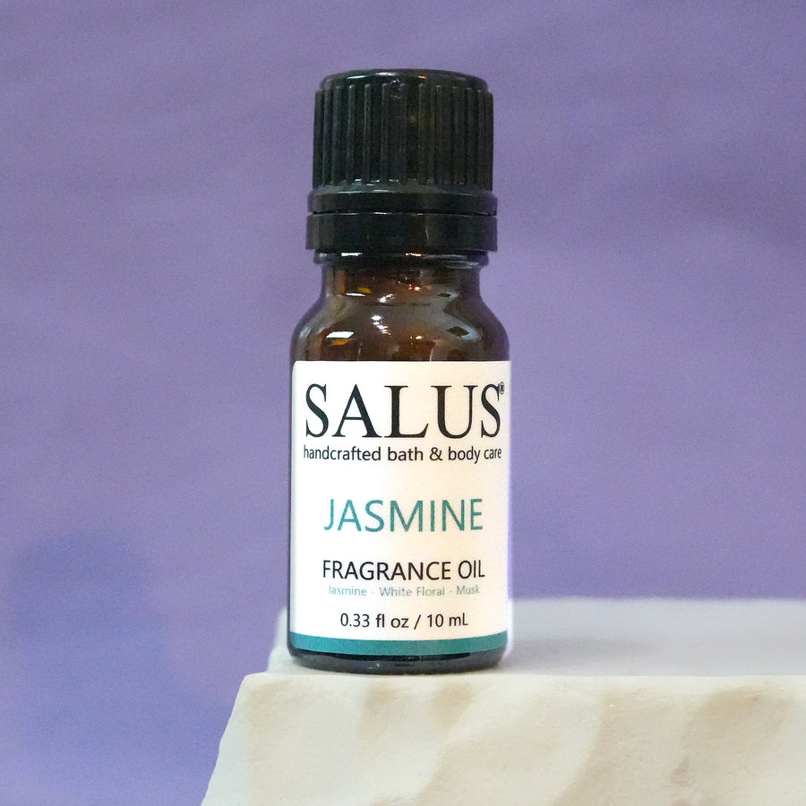 SALUS Jasmine fragrance oil, 10 mL amber bottle on a white stone pedestal.