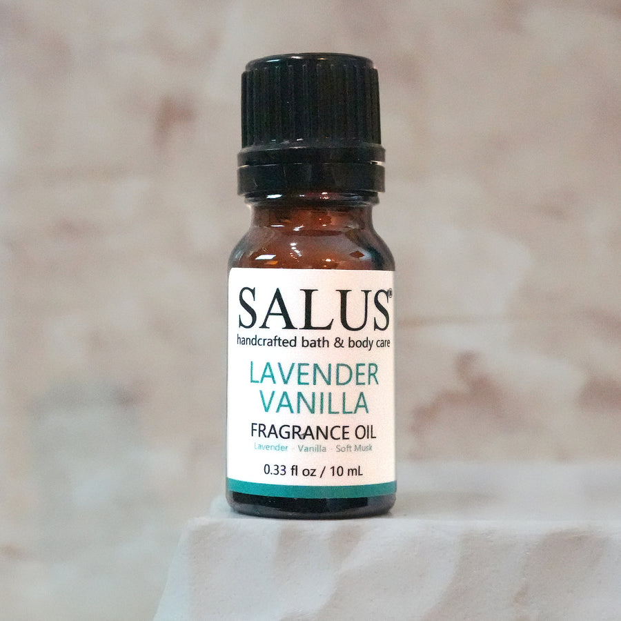 SALUS Lavender Vanilla fragrance oil, 10 mL amber bottle on a white stone pedestal.