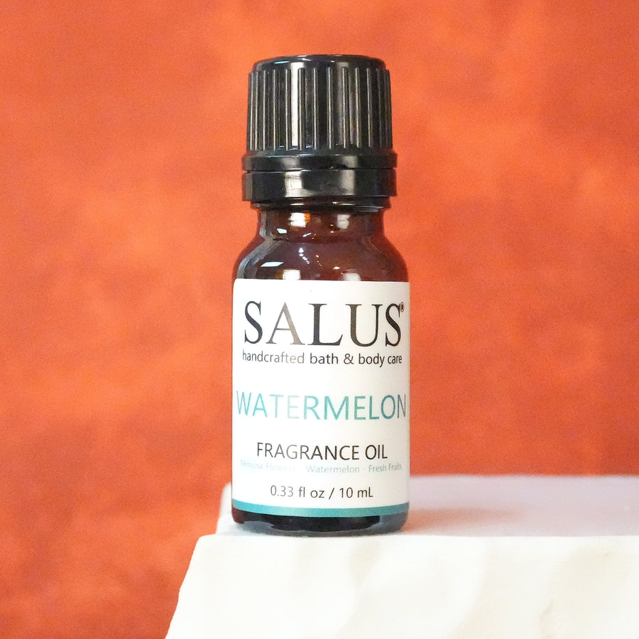 SALUS Watermelon fragrance oil, 10 mL amber bottle on a white stone pedestal.